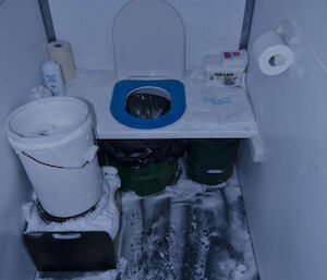 Toilet in field hut covered in ice