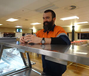 Expeditioner looking over a bench towards food preparation area