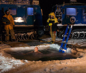 expeditioner in the icy cold water with a comfortable expression on his face