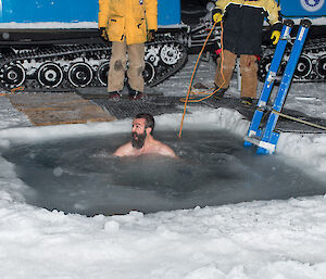 Expeditioner in the icy water with mouth side open