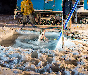 Expeditioner rushing to climb the ladder and exit the icy cold water