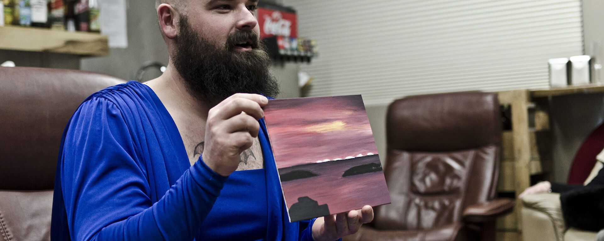 Expeditioner holding a small painting