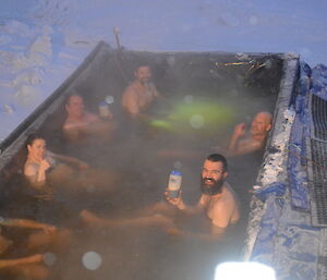 Expeditioners soaking in a large outdoor hot tub
