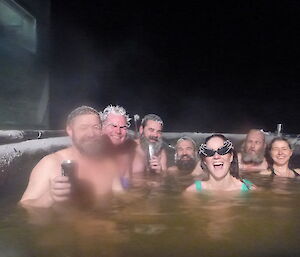 6 expeditioners enjoying the outdoor hot tub