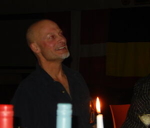 Expeditioner at formal dinner table listening to speech