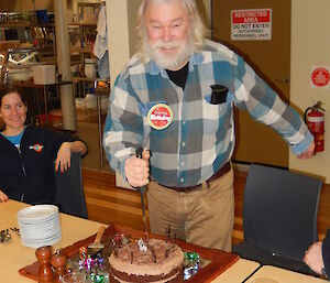 Expeditioner cutting into a large chocolate cake