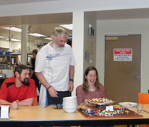 Expeditioner handing a cake to another expeditioner