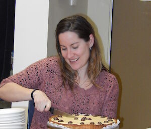 Expeditioner cutting a birthday cake into 20 slices