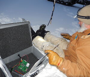 Expeditioner stilling on sea ice with science measuring instruments