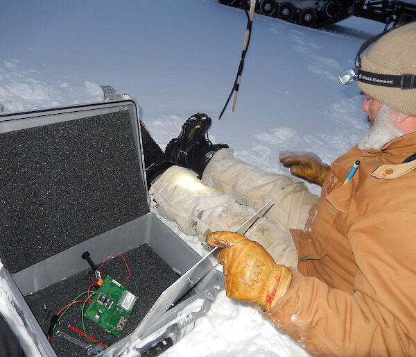 Expeditioner stilling on sea ice with science measuring instruments