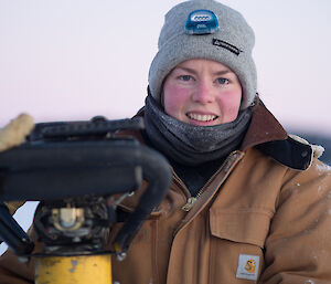 Close up photo of expeditioner holding a jiffy drill