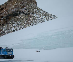 Hägglunds driving past a large ice sheet