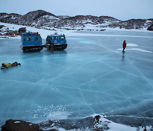 Blue Hägglunds parked on frozen lake