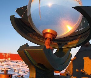 Glass sphere with the sun shining through onto a card