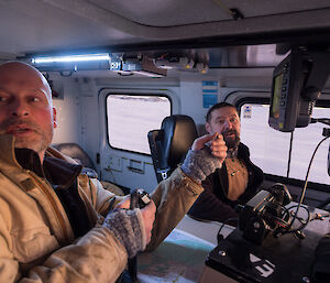 Two expeditioners sitting in the front seats of a hagglunds
