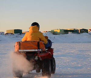 Quad bike and rider heading towards station, riding on the sea ice
