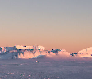 Crumbling small iceberg in the sea ice