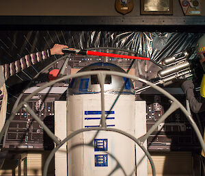 Two Star Wars characters taking R2D2 hostage