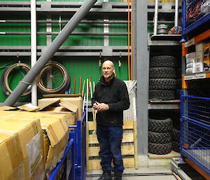 Expeditioner standing next to numerous large boxes in the warehouse