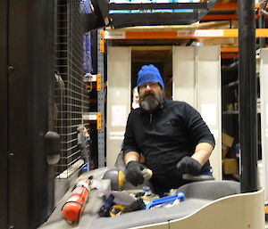 Expeditioner driving a forklift in the warehouse