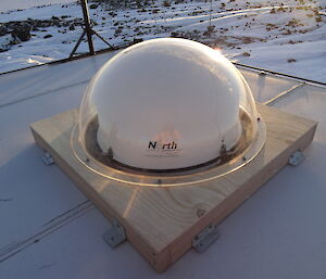 Clear dome over white dome on the roof of a hut