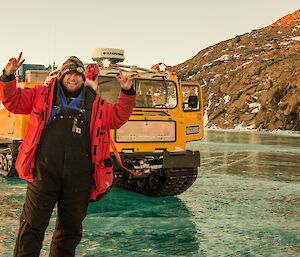 Expeditioner taking a photo of himself on a smooth blue frozen lake