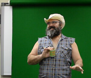 Expeditioner dressed as a cowboy holding a can of pet food