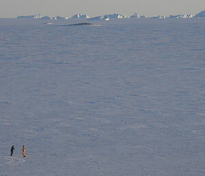 Long distant photo of two expeditioners dancing on the sea ice