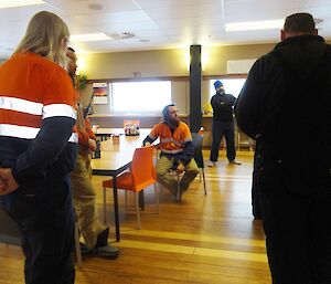 Team gathered around two expeditioners making an accouncement