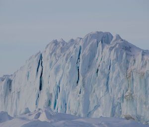 Blue ice berg with vertical cracks