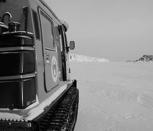 Hagglund parked on the sea ice with a large glacier 2km away