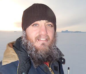 Close up photo of expeditioners face, beard covered in ice