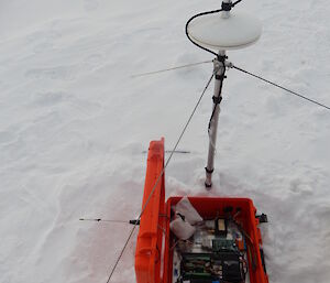 Electronic equipment in a red case on the sea ice