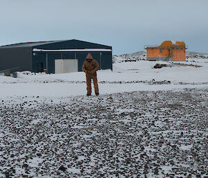 Expeditioner rolling out a cable along the ground