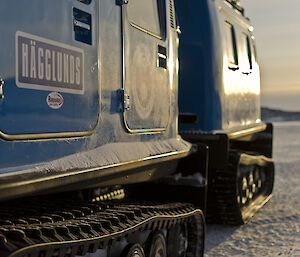 Photo showing a close up of the side of a blue hagglund