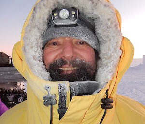 Close up photo of expeditioner wearing thick yellow antarctic jacket