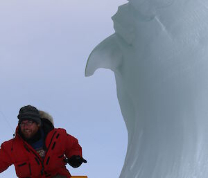 Expeditioner pretending to ride icy wave formation