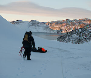 Rope and sled in position, people in the far distance down at the lake