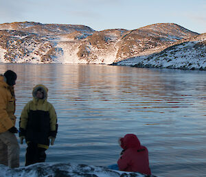 Three expeditioners at the lake edge