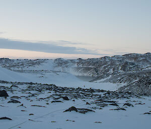 View from top of valley down to lake person in the distance with rope