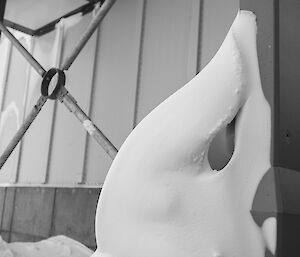 Snow crawling up the side of a building