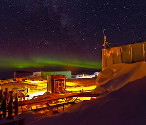 Aurora green lights over station buildings