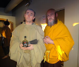 Two expeditioners wearing clothing similar to a religious brother