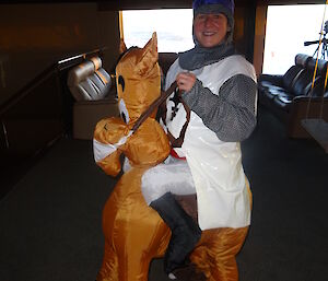 Expedtitioner dressed as a Knight riding an inflatable horse