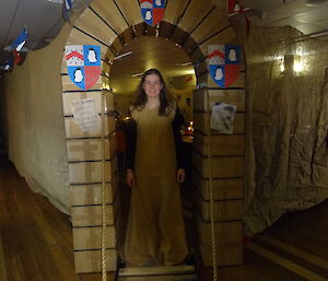 Expeditioner dressed in medieval dress walking through the castle entrance