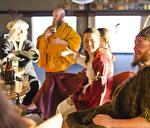 People dressed in medieval costumes enjoying a drink at the bar