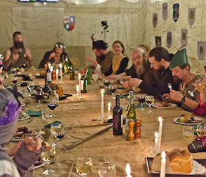 Group of people sitting around a table decorated in medieval theme