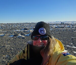 Expeditioner taking self photo with sea ice and hagglund in the background
