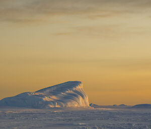 Iceberg and a yellow sunset
