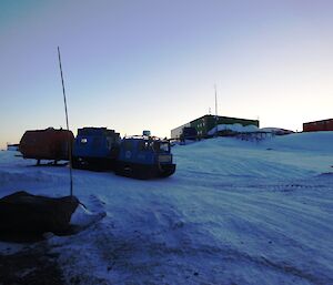 Blue Hägglunds towing a small accommodation van